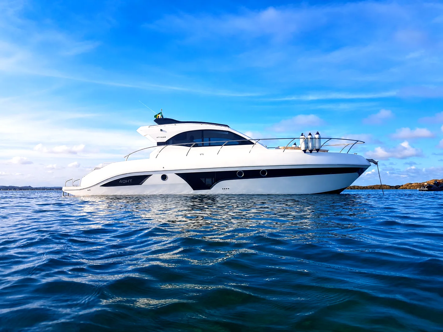 Atymar 40 HT — motorboat on calm water under a clear blue sky